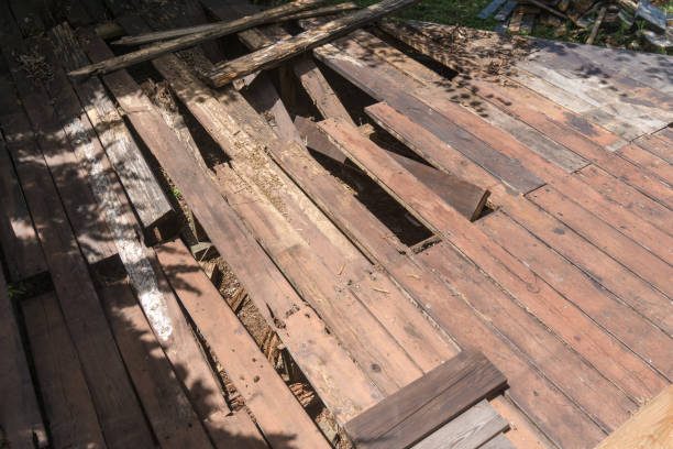 Weathered wooden deck with damaged boards in need of repair