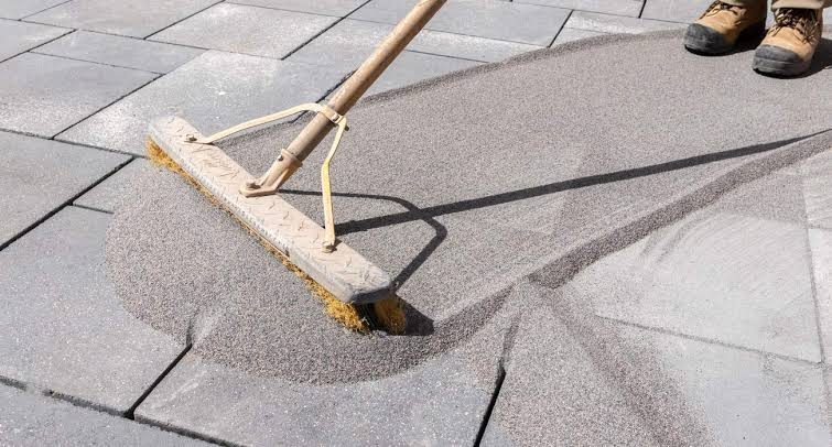 Sweeping polymeric sand into paver joints