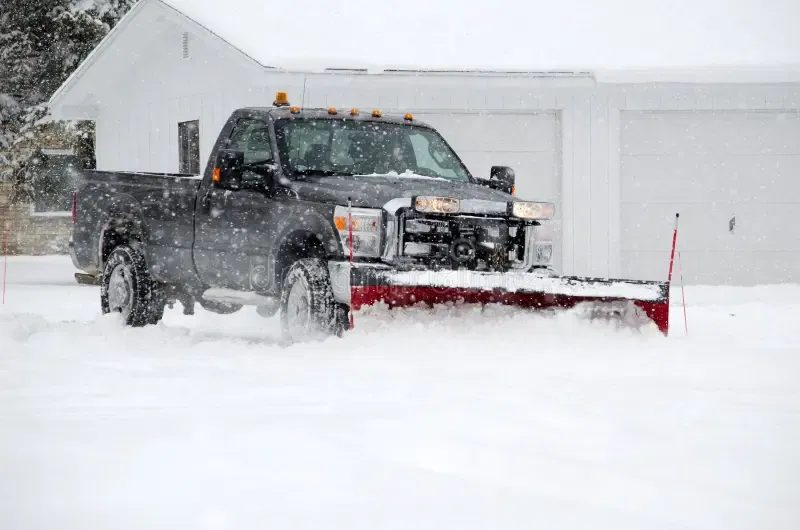 Snow removal in progress on a residential driveway